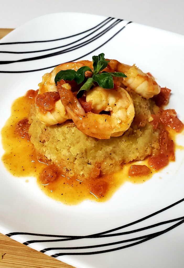 homemade mofongo topped with sauteed shrimp