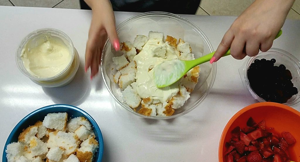 Assemble the no bake berry trifle by starting with a layer of angel food cake.