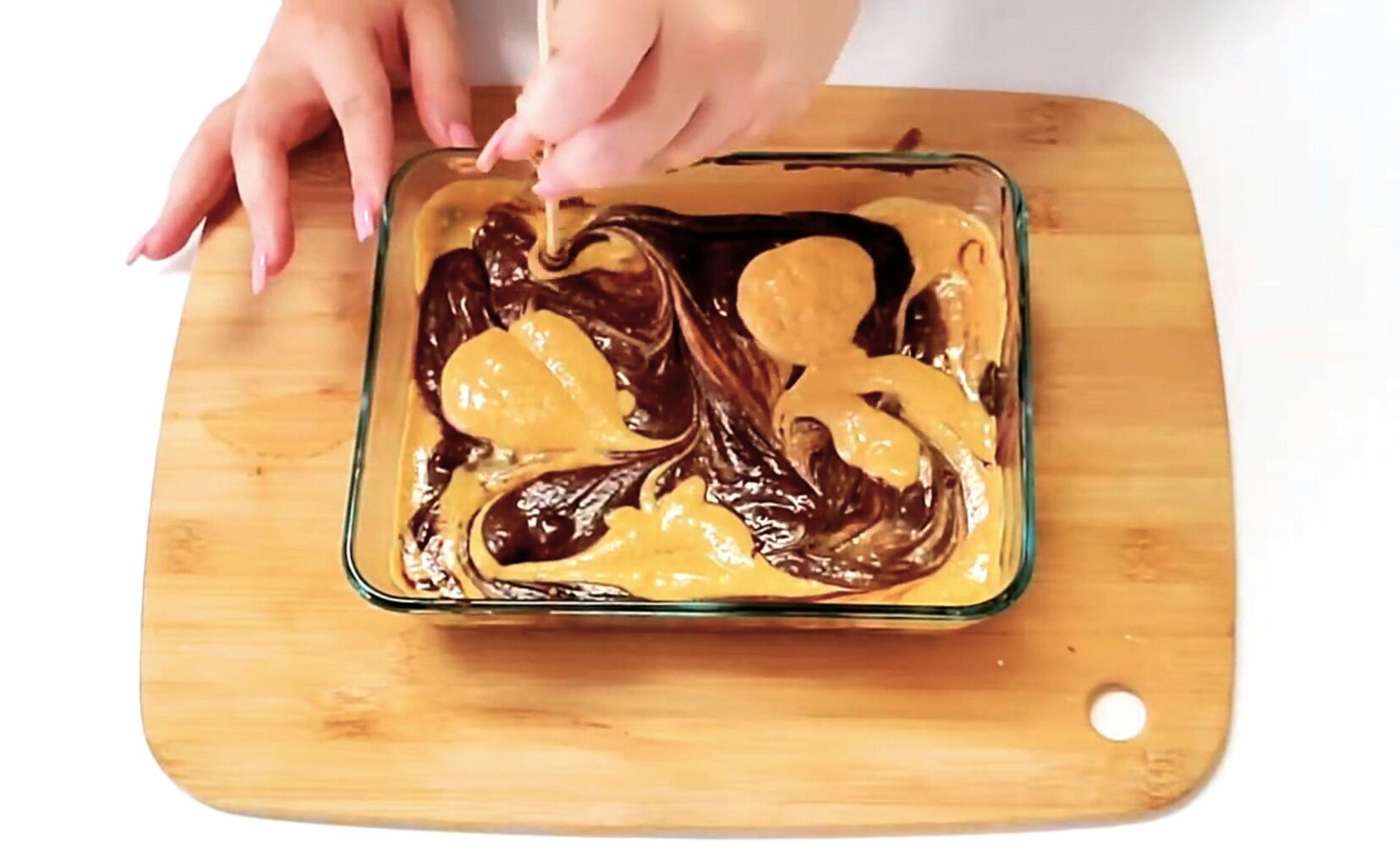 swirl ribbons of pumpkin cheesecake filling with chocolate brownie batter