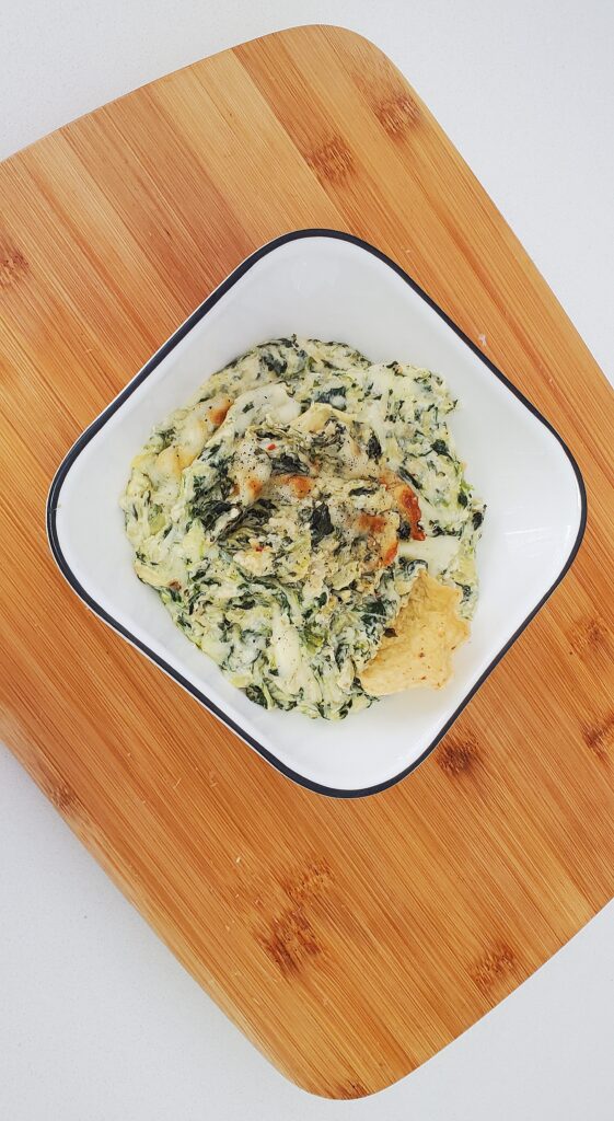spinach artichoke dip served with tortilla chips