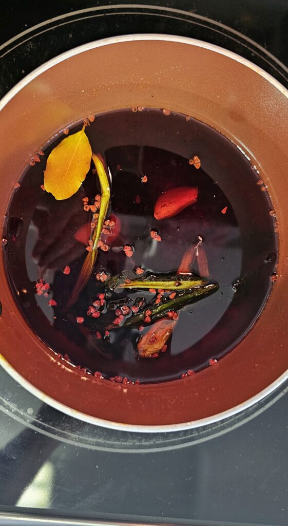 homemade achiote oil infused with garlic, culantro and bay leaves