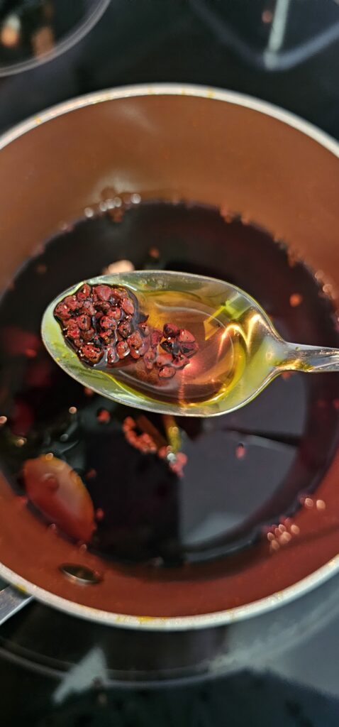 close up shot of annatto seeds inside a pot, while making Puerto Rican Achiote Oil